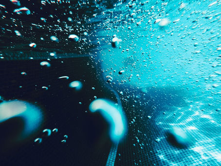 Bubbles rising in a swimming pool underwater