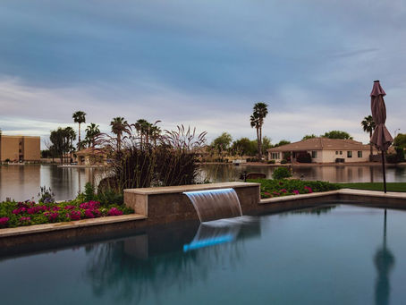 serene backyard pool with waterfall and lake