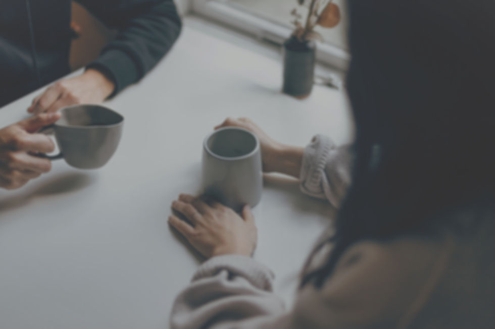two people sitting drinking coffee together