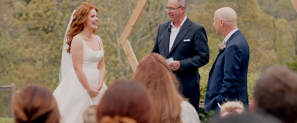 bride, groom, and officiant at a wedding ceremony outside on cape cod.
