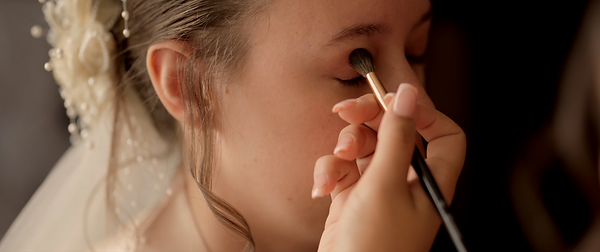 bride getting her makeup done the morning of her wedding