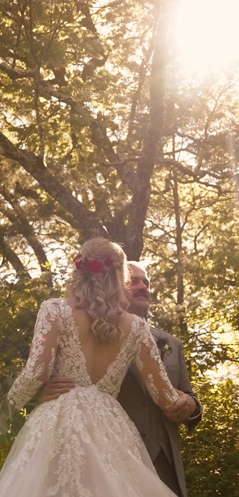 bride and groom hugging under a tree