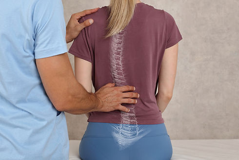 Healthcare provider assessing spine alignment for spinal decompression in Roseville, CA