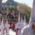 A holy week procession in Madrid with people wearing traditional procession costumes that date back to the Spanish Inquisition