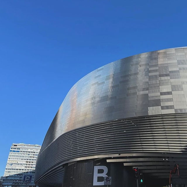 The renovated curved metal exterior of Santiago Bernabéu Stadium in Madrid.