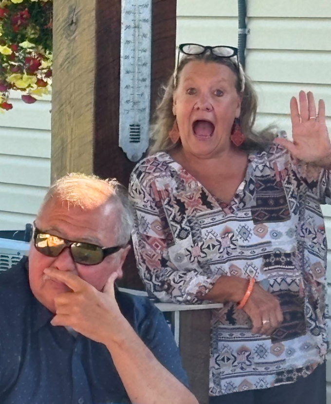 Boonslick Master Gardener summer social; member smiling and waiving a big welcome.