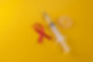 red-ribbon-latex-condom-syringe-blue-table.jpg