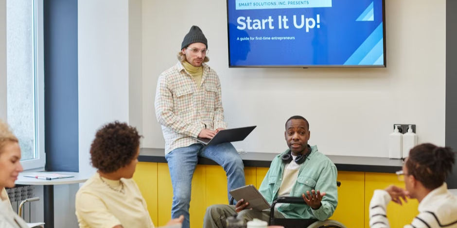 Inclusive team meeting discussing startup strategies at a modern office setting.