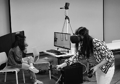 A woman wearing an XR headset interacts with a virtual environment.