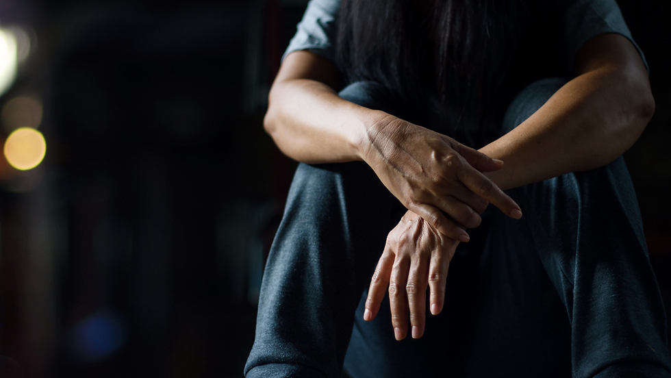 a person sitting down with their hands crossed