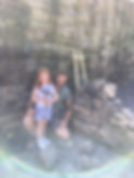 Gary from Earth, Stone & Mortar with his daughter, smiling beside a hand-built dry stone wall in progress in Buxton.jpg