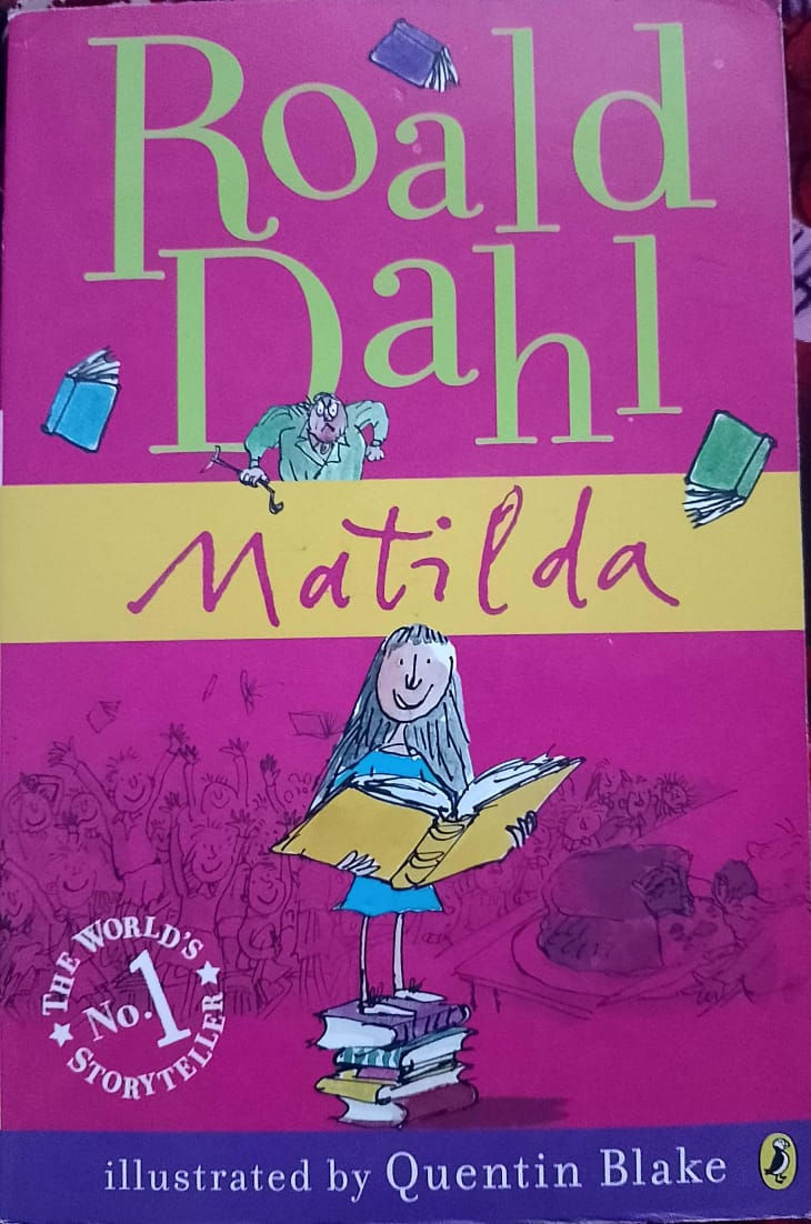 Matilda book cover; Roald Dahl; girl reading large book