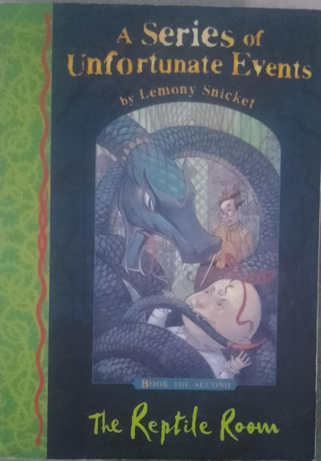 Unfortunate Events book cover: Lemony Snicket's book cover features a large snake and children