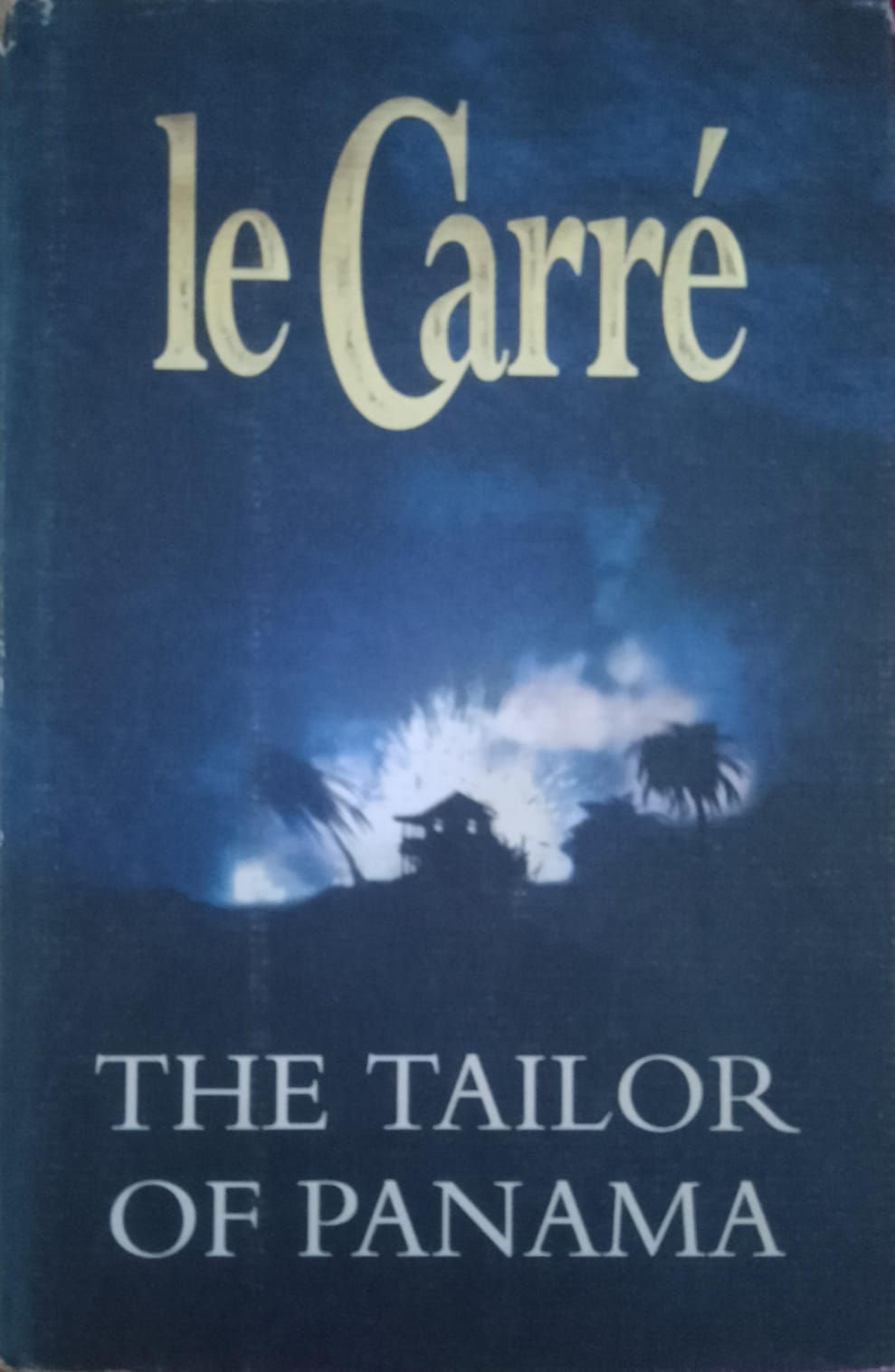 John le Carré book cover, THE TAILOR, dark blue, dramatic background.