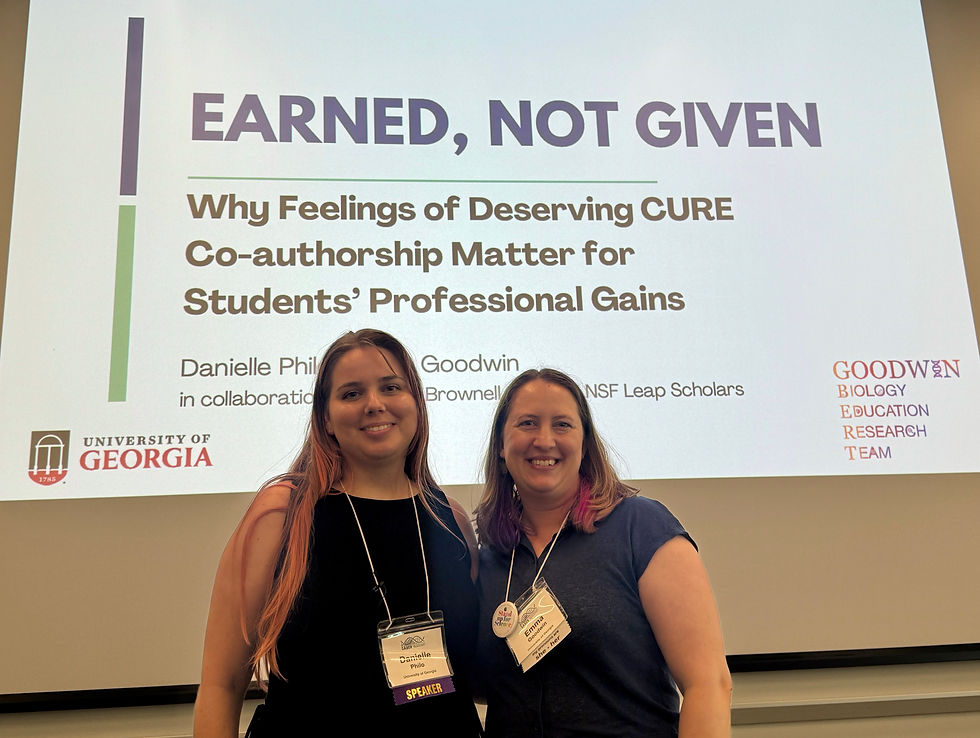 Emma and Danielle in front of Danielle's presentation title slide (Titled "Why Feelings of Deserving CURE Co-authorship Matter for Students' Professional Gains").
