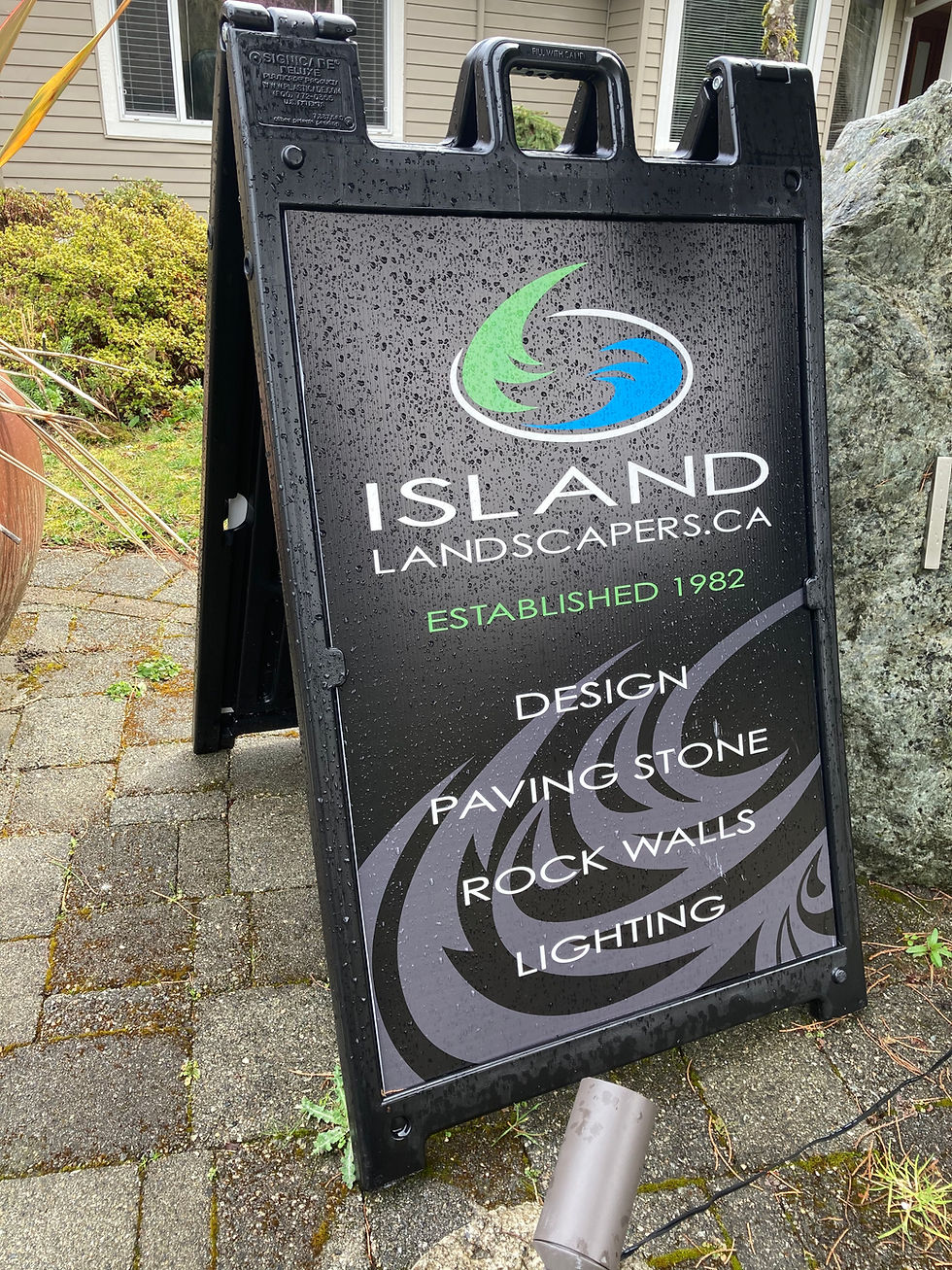 Island Landscapers Inc. sign in black featuring design, paving stone and rock walls.