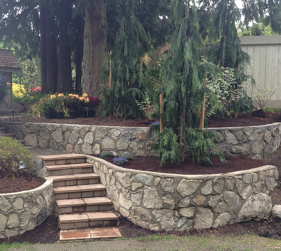 Terraced gardens retained by curved rock walls and stairs.