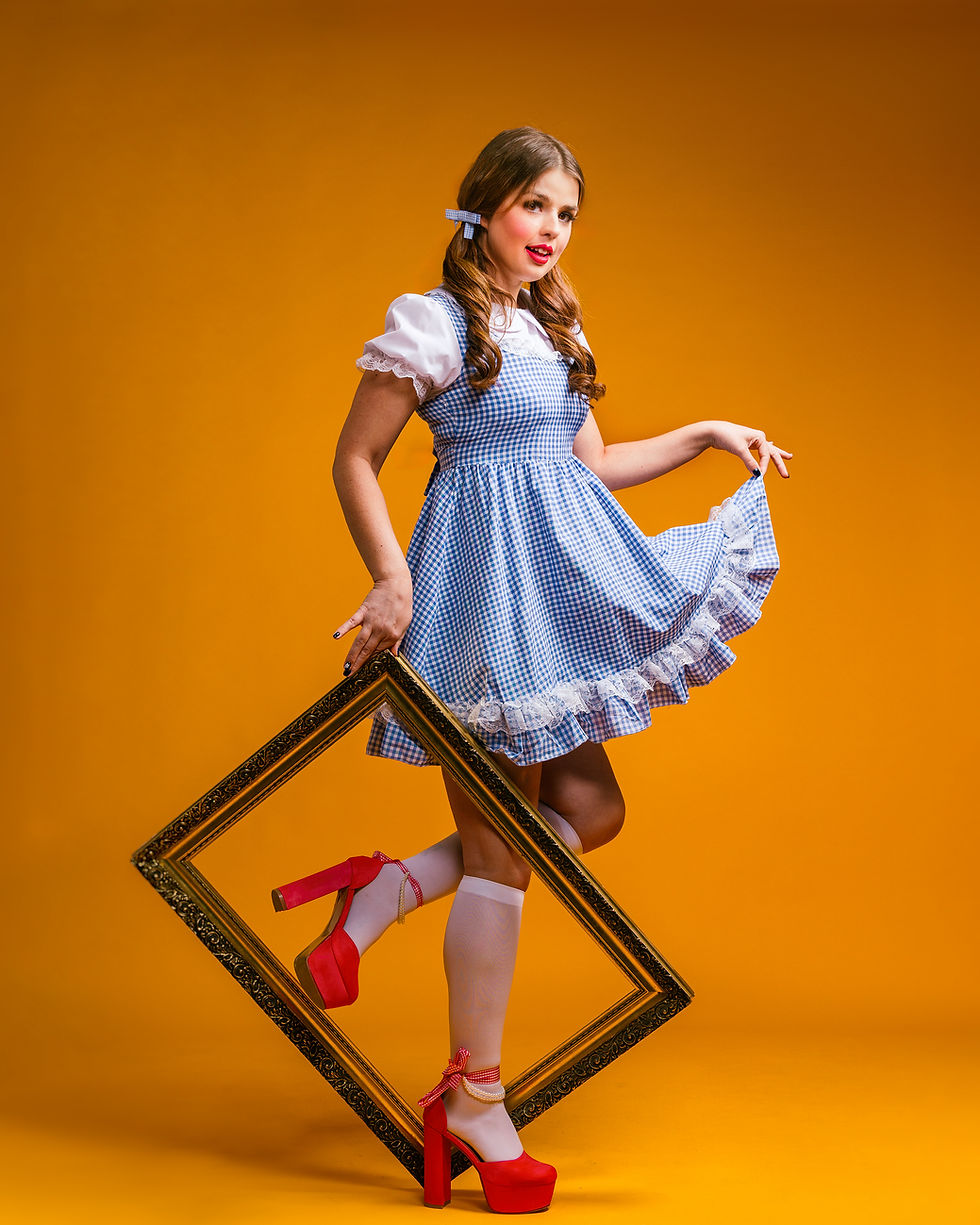 Wrestler Zoe Lucas in Dorothy Cosplay on a bright yellow background