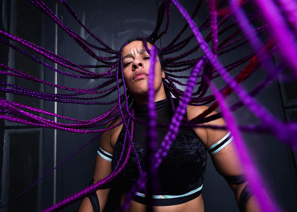 Wrestling Star Rhio with purple hair spreading out to camera