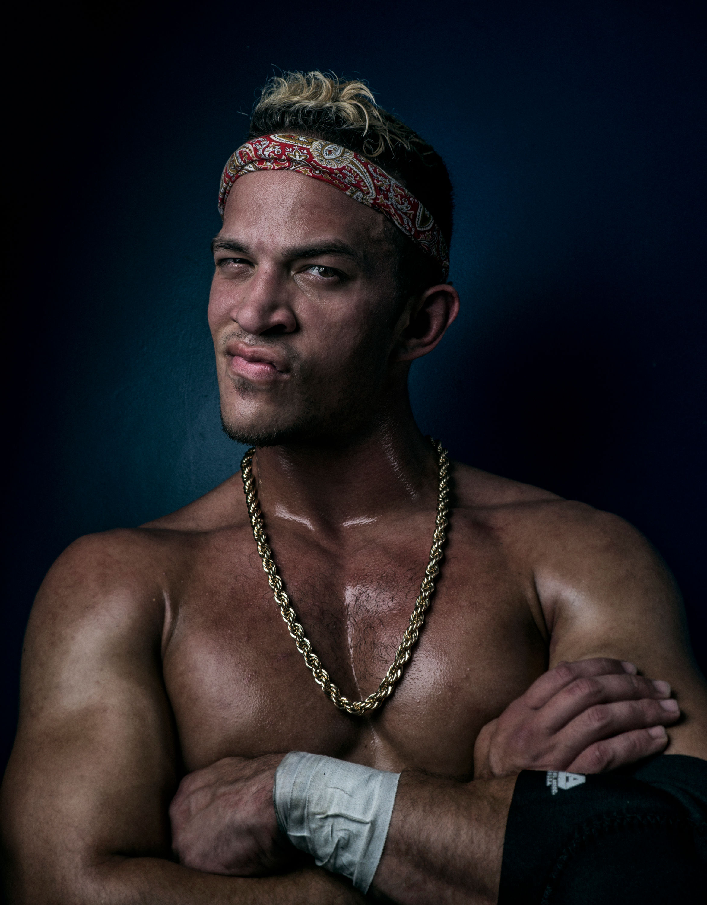 Ricky Saint in folded arms pose with smug side eye.