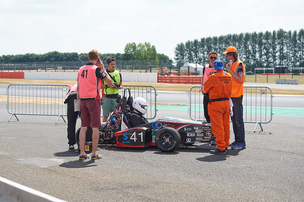 The driver and team await the off for a practice with the car prior to the timed events