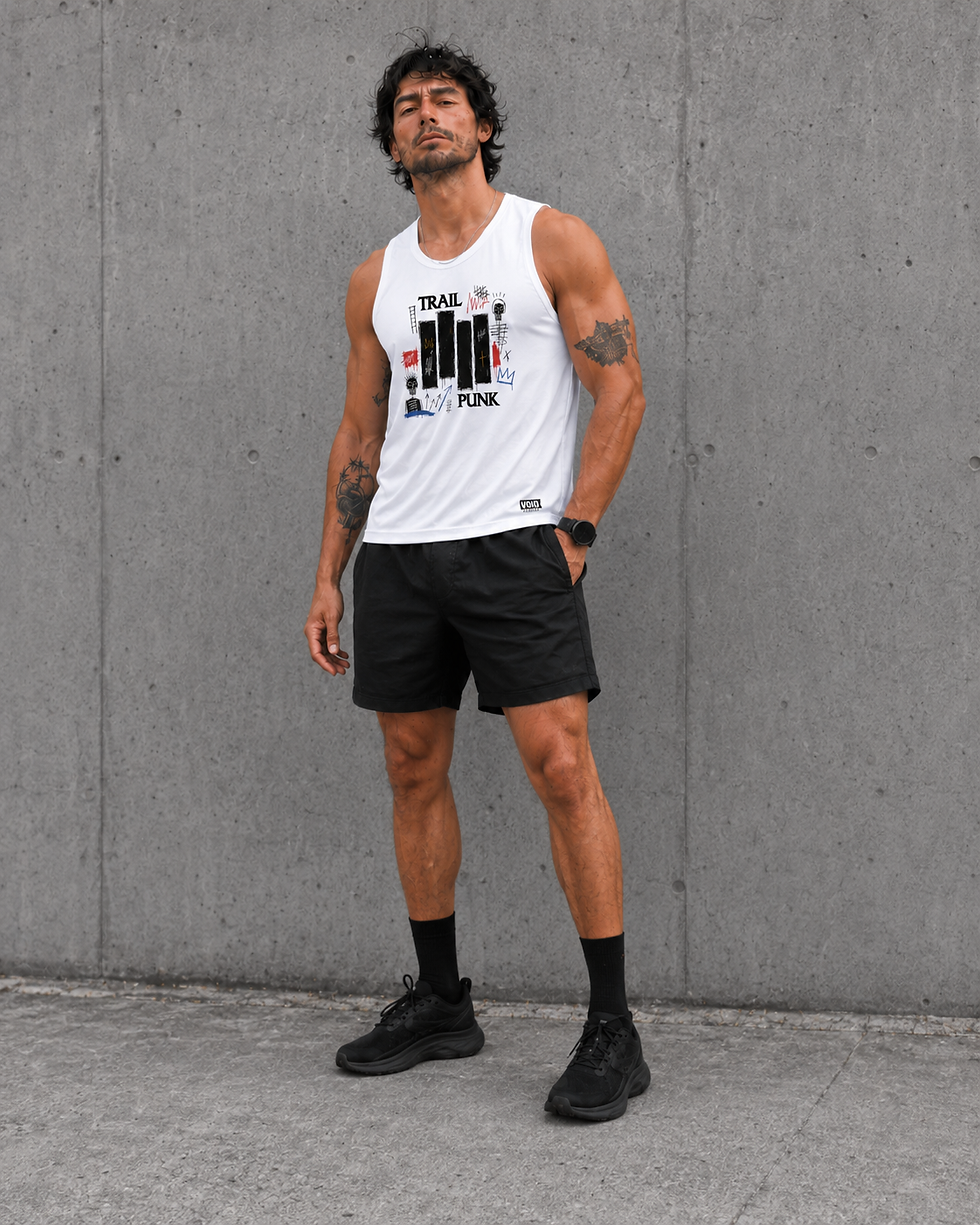 Male runner wearing the white Trail Punk running vest with black shorts and running shoes against a concrete wall.
