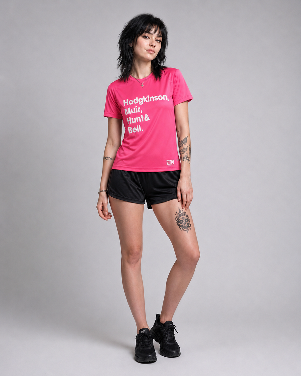 Female model wearing a bright pink VOID Running technical tee with white Hodgkinson, Muir, Hunt and Bell text.