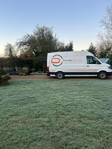 Company van displaying our drainage company contact information.