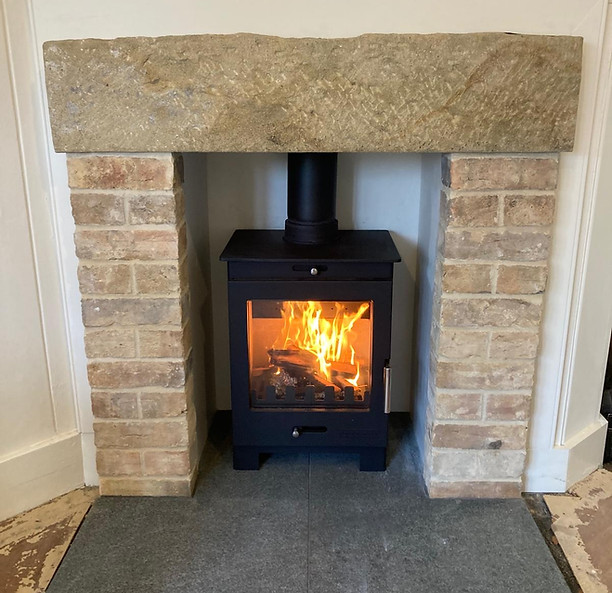 Wood burner in stone mantle