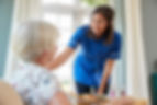 care-nurse-serving-dinner-to-a-senior-wo