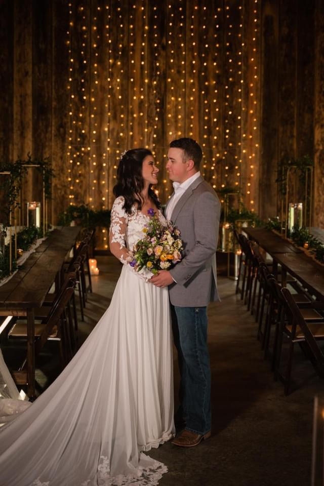 Winter Wedding, Smoky Mountians, Bride, Groom, Twinkly lights, farmhouse tables, bridal gown, suit jacket, boots