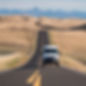 Sprinter van driving down wind eastern washington state road, no license place.jpg