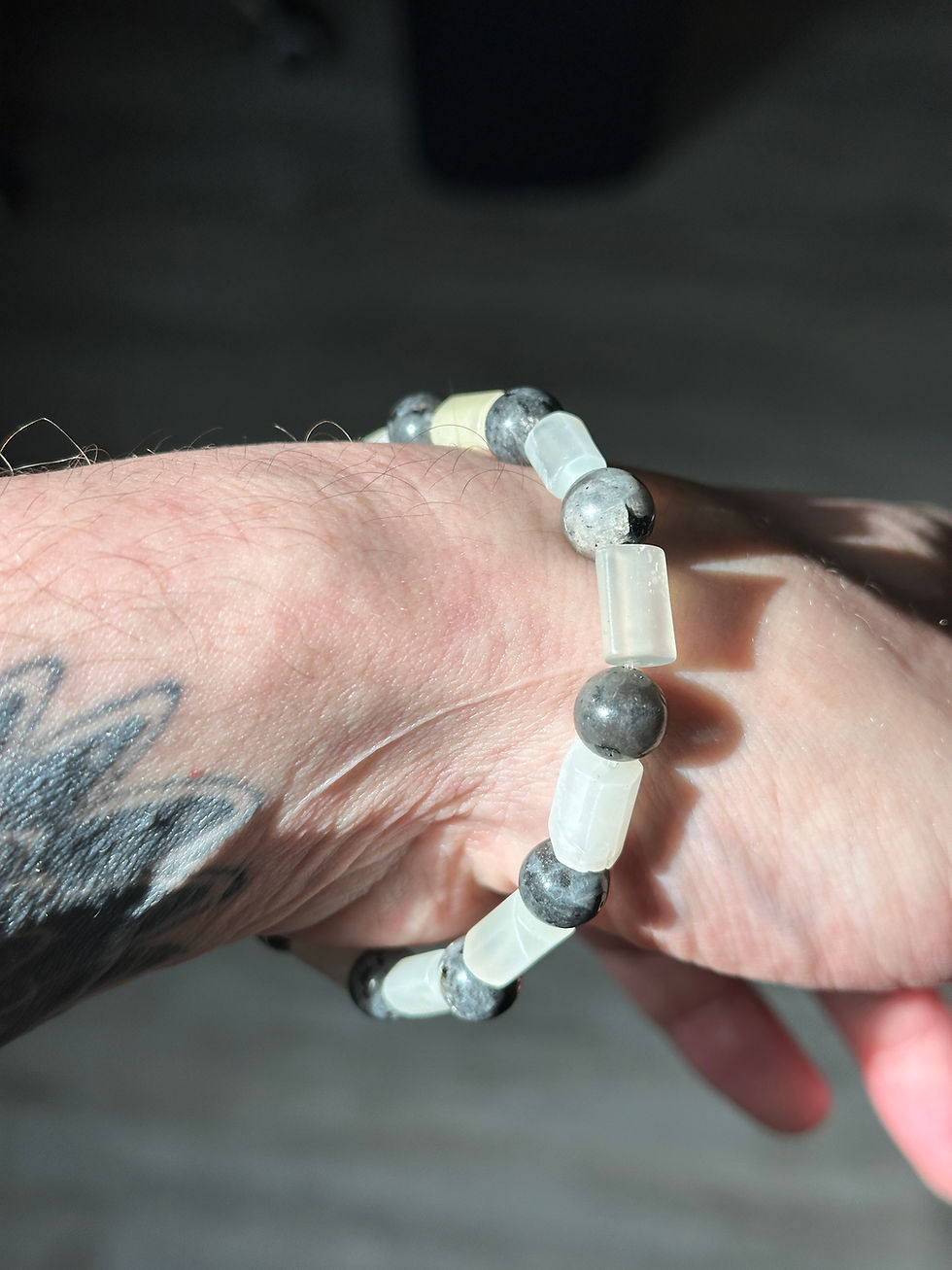 Bracelet de perles sur un poignet tatoué