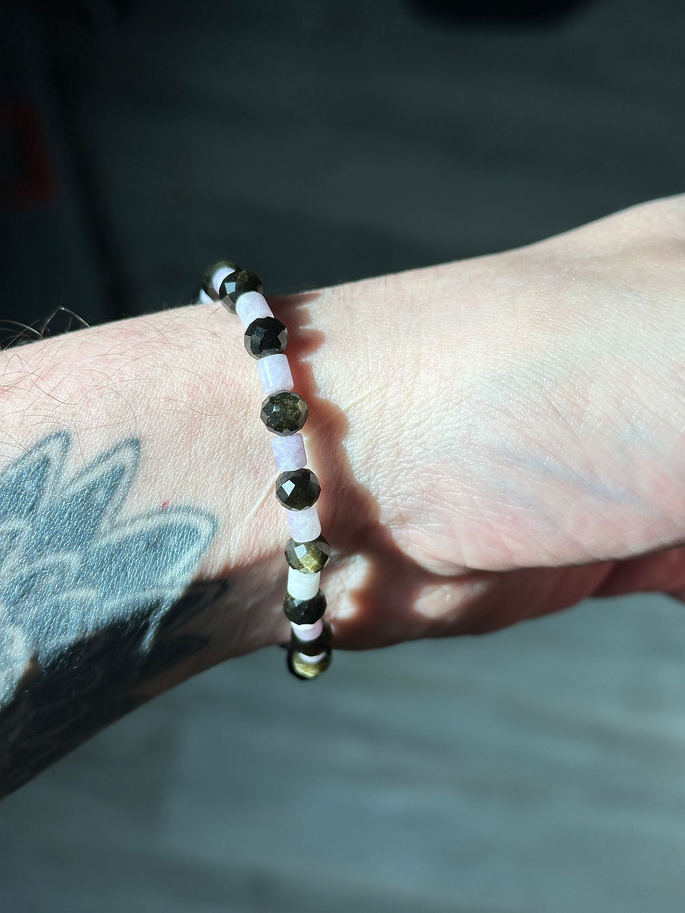 Bracelet perlé noir et blanc sur un poignet