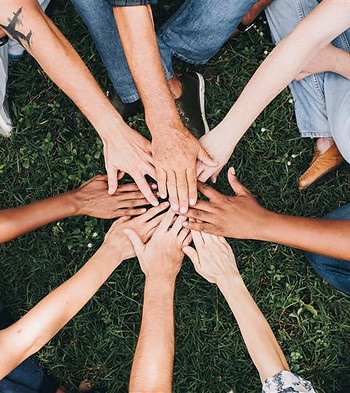 people-stacking-hands-together-park.jpg