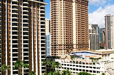 tall-brown-skyscrapers-green-palms-before-them.jpg