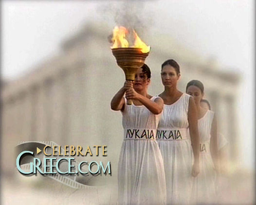 Image of a scene from "The Quest for the Athlos" depicting the lighting of the Modern Olympic Torch at the ancient Olympic archaeological site in Olympia, Greece