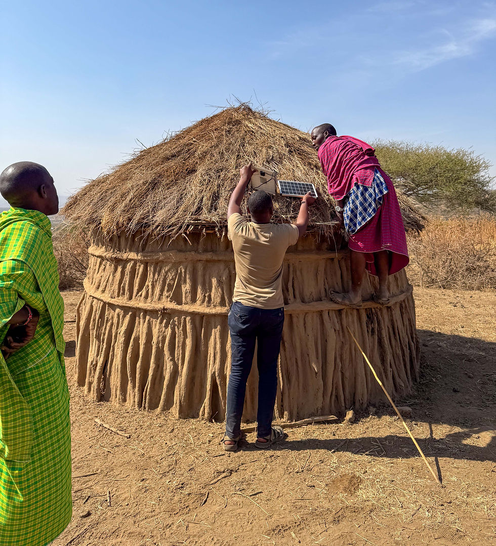 Ethical Indigenous tourism in Tanzania showing Maasai community members installing solar energy on a traditional home, demonstrating community-led development, sustainable support, and responsible alternatives to giving money or gifts directly to individuals.