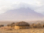 Maasai village in front of the Ol Doinyo Lengai (Mountain of God in the Maasai language),
