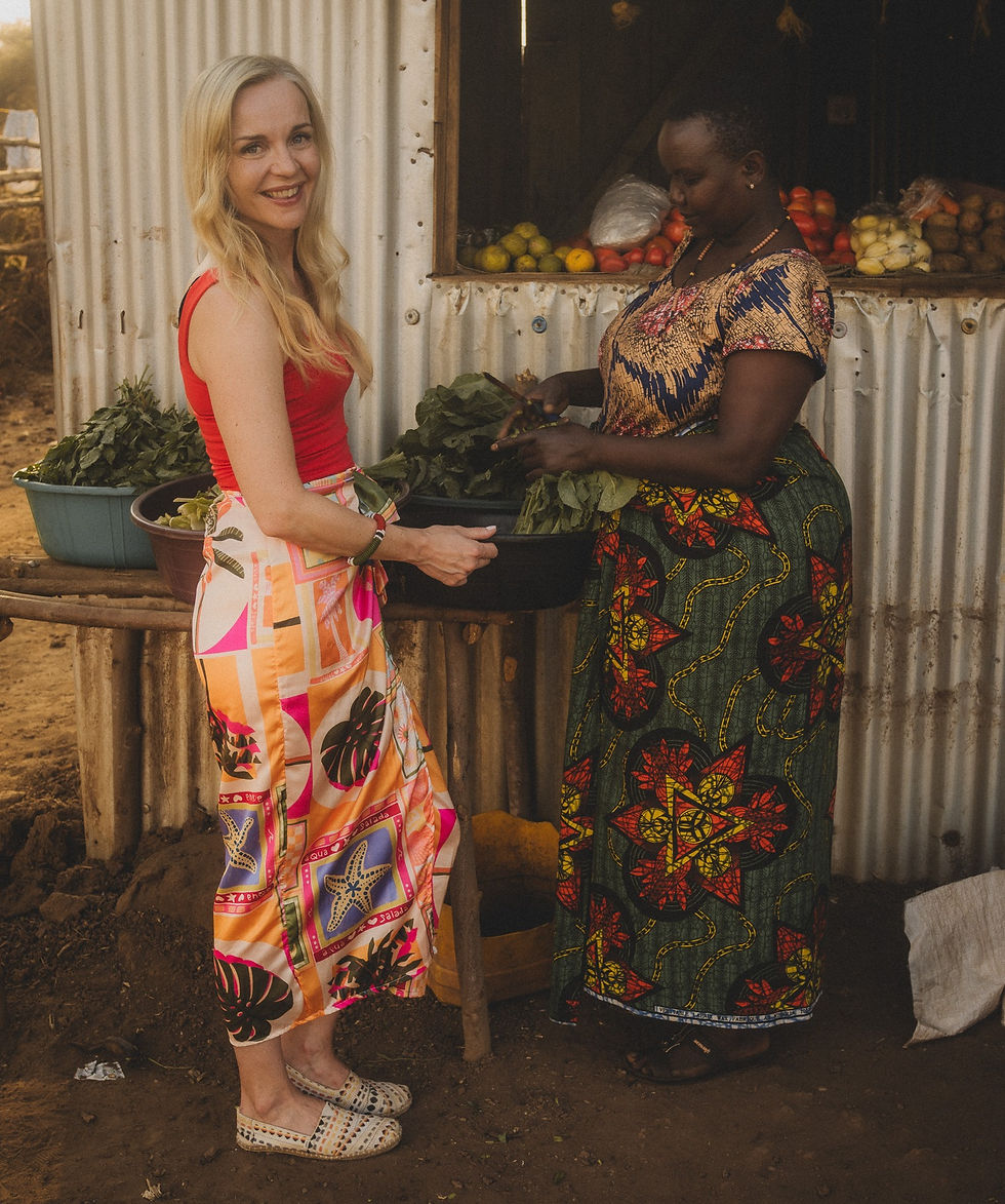 Anniina Sandberg with local woman at Tanzania market, Indigenous travel experience and cultural exchange
