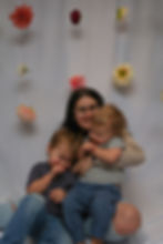 Victoria sitting and laughing with her two kids