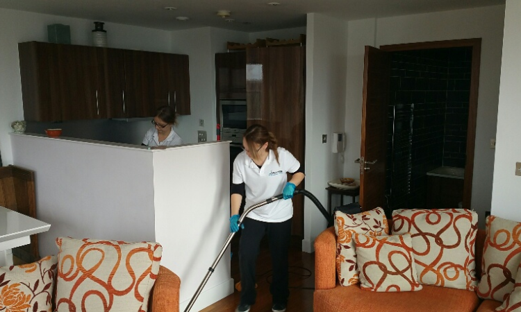 Mr & Mrs Cleaning team cleaning an apartment kitchen and living area