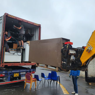 School Cupboards loading into a container with a tractor