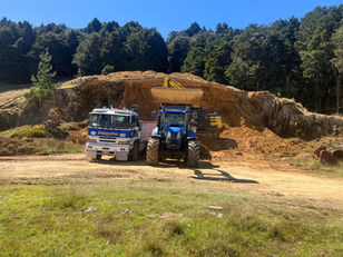 Dempster Diggers truck, tractor and digger working in a farm quarry