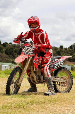 Thumbs up from this happy rider sitting on his motorbike at the end of the trail ride