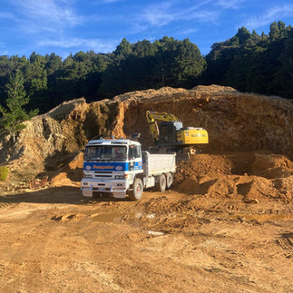 Dempster diggers loading into a truck in a farm quarry