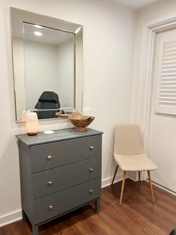 Aesthetic treatment room with large mirror and trendy decorations