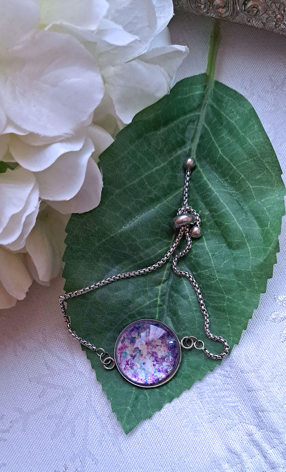 Thumbnail: An adjustable slider bracelet designed by Studio 1153 will add a fun pop of color to your year round looks.