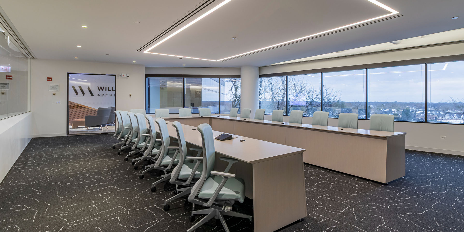 Modern conference room with a long table and large windows