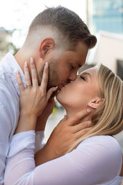 Beautiful couple kissing on the streets of downtown Boise, Idaho during an engagement session with Summit & Sage Photography.